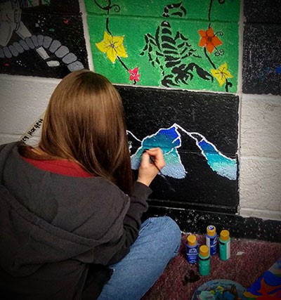 student working on an art project